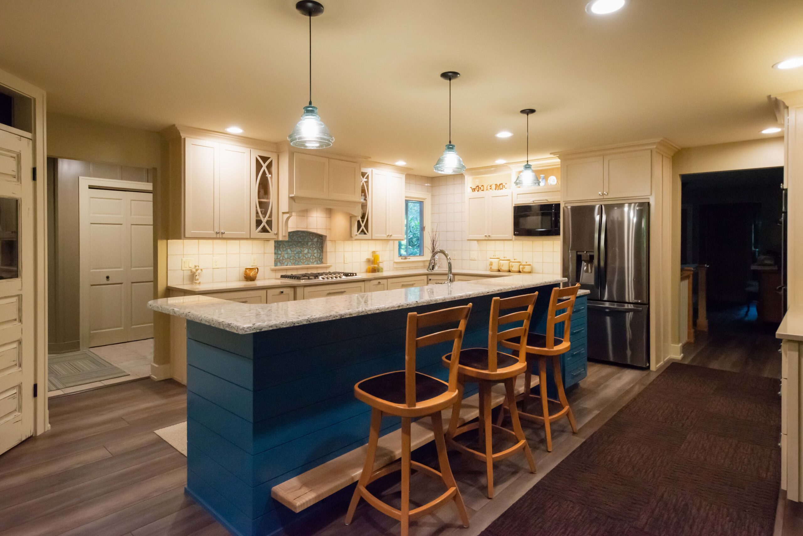 Kitchen with blue island bar and cabinetry