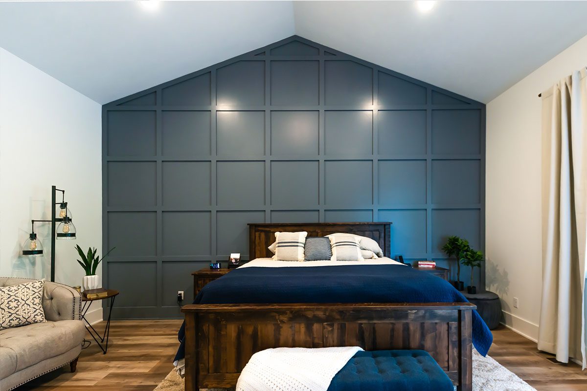 Large bedroom with dark blue accent wall